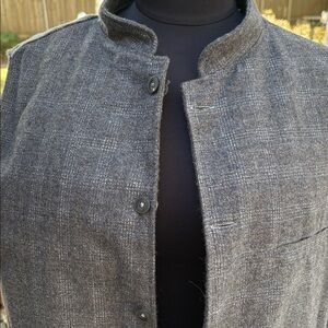 Reversible sleeveless wool vest with a stand-up collar and button-down front